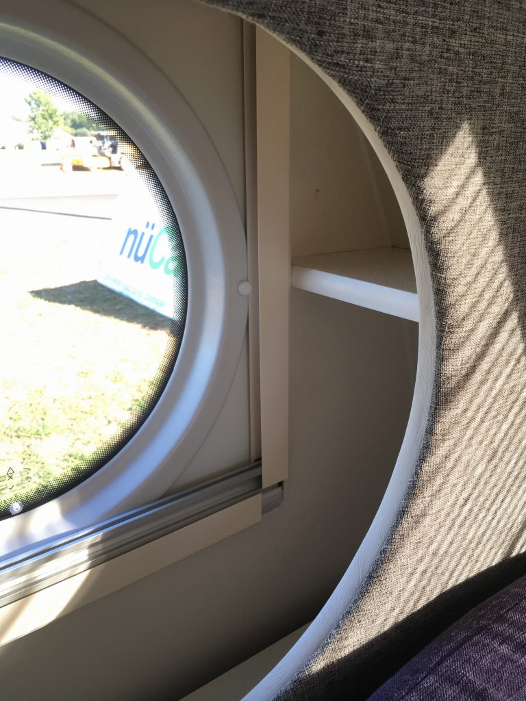 The table area includes unique storage within the porthole windows.